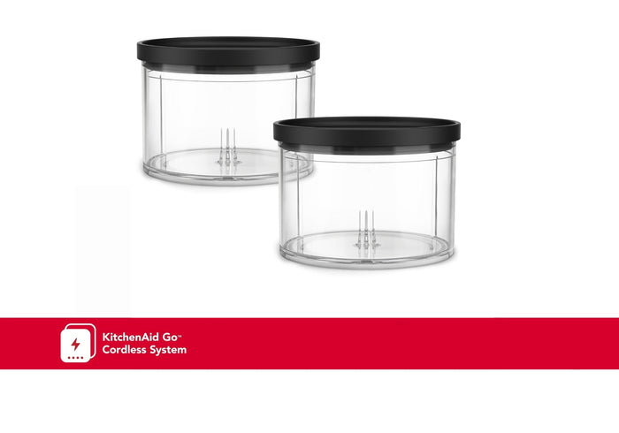 Two clear plastic chopper bowls with black lids, one larger than the other, with a KitchenAid logo in red on the bottom.