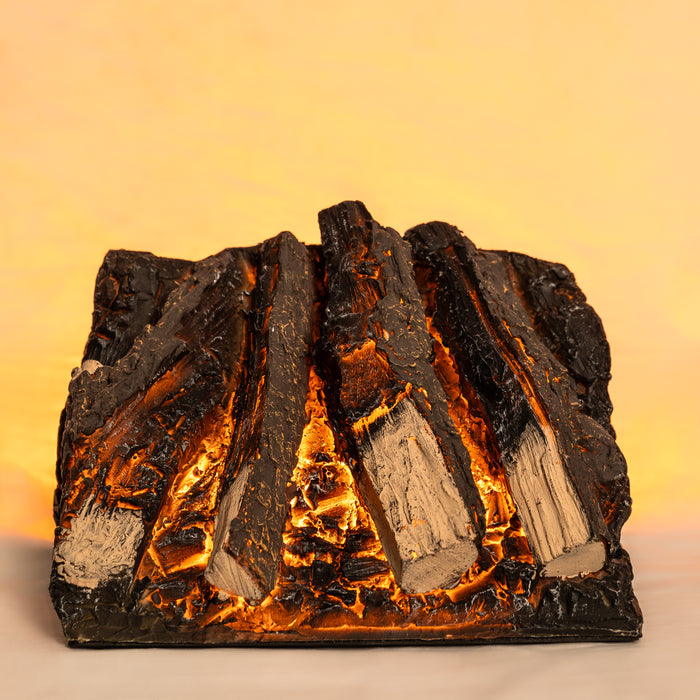 Artificial log set with glowing embers on a beige background